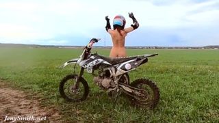 Naked woman riding a Dirt Bike