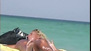 A sexy model couple on the beach voyeur video