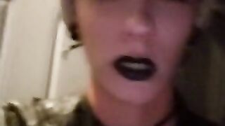 punk smokes a cigarette outside at night