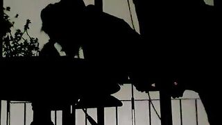Silhouettes in the balcony at night