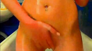 Tattooed model plays with glass dildo
