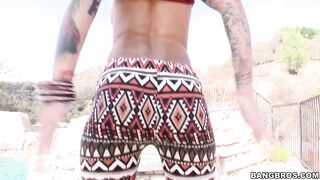 Badass inked model posing by the pool