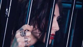 Brunette slave gets fucked in a cage by two