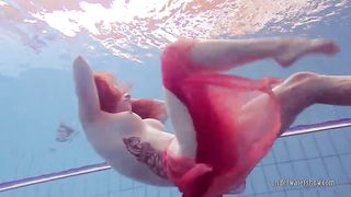 Redhead dancing in the pool