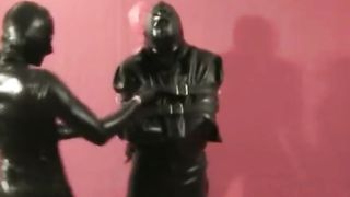 Threesome Latex Catsuits two Femdom Girls Bondaged Slave in Straightjacket