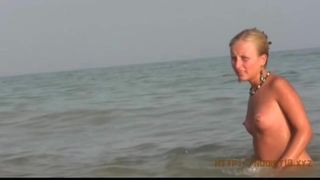 Beautiful fresh faced teen plays at the beach nude